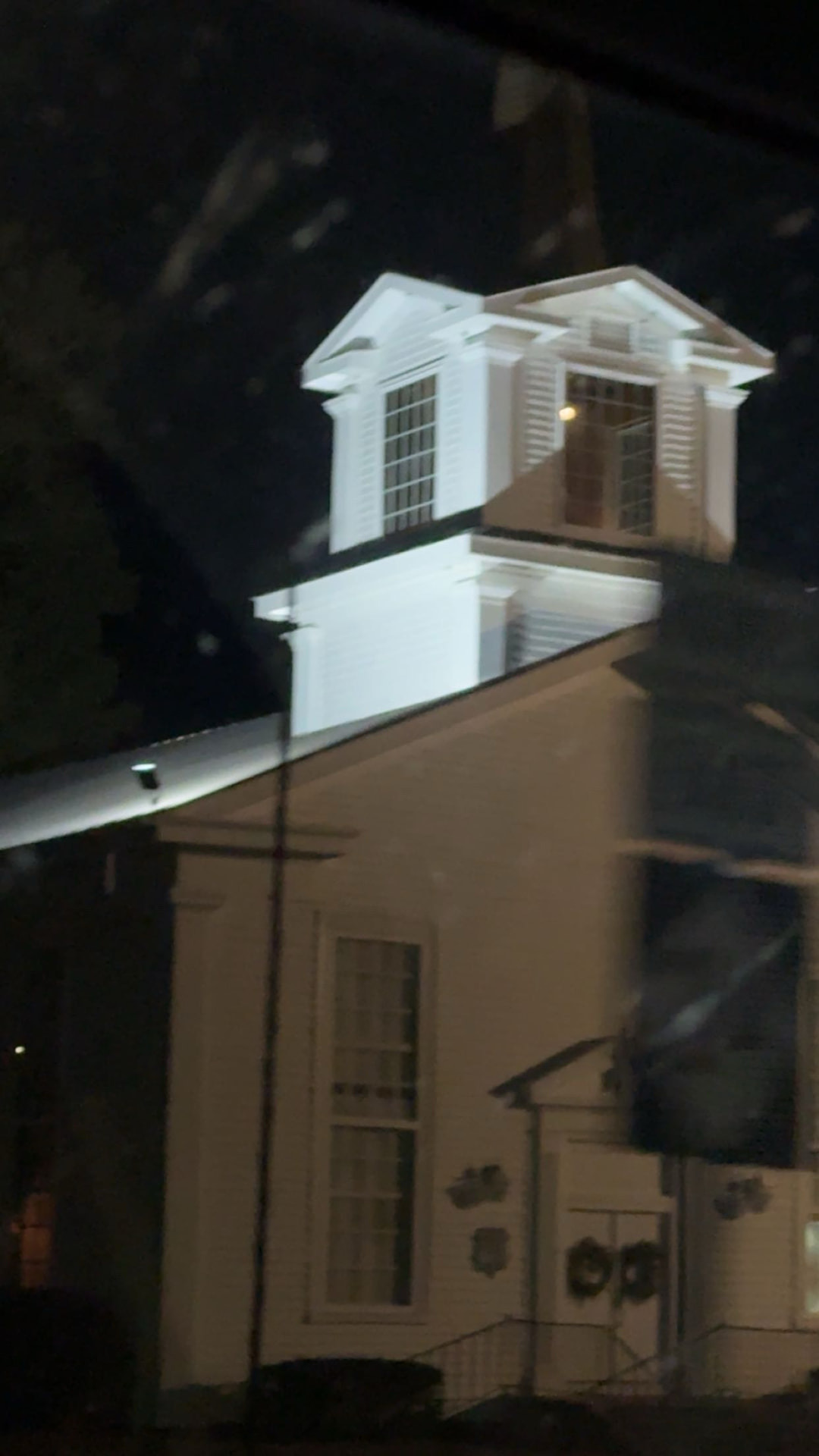 Church steeple lit up at night with custom floodlight installation